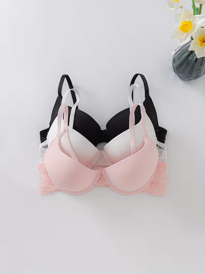 3er Pack Damen BH Set in Rosa, Weiß und Schwarz auf hellem Hintergrund