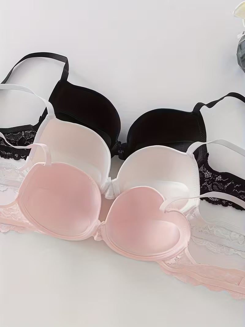 Drei Damen BHs im Set in Rosa, Weiß und Schwarz mit glatten Cups und Spitze