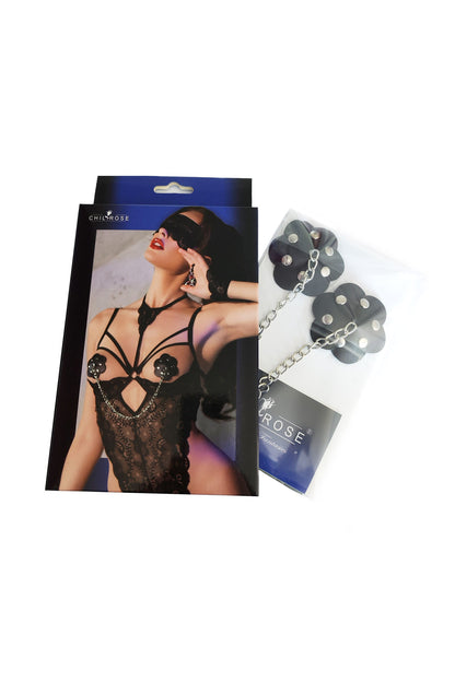 Nipple covers made of black imitation leather with silver rivets and chain